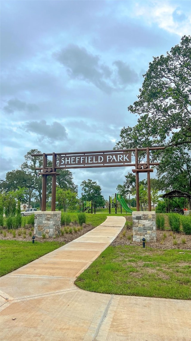 view of community featuring playground community and a yard