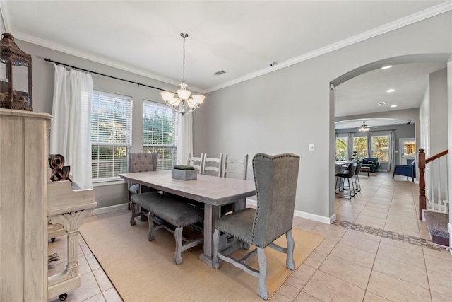 dining area with crown molding, stairway, light tile patterned flooring, and arched walkways