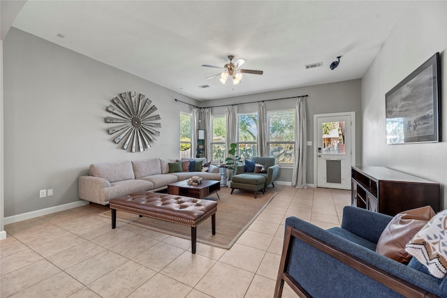 living area featuring visible vents, baseboards, light tile patterned flooring, and a ceiling fan