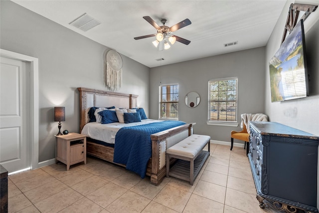 bedroom featuring light tile patterned floors, visible vents, baseboards, and a ceiling fan