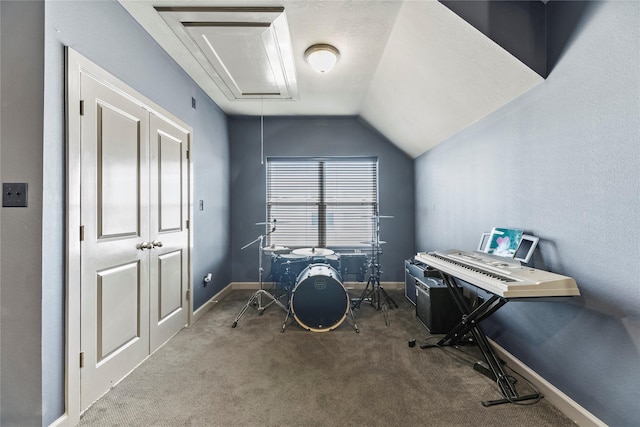 interior space featuring baseboards, attic access, lofted ceiling, and carpet floors