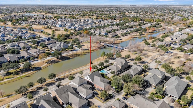 bird's eye view featuring a residential view and a water view