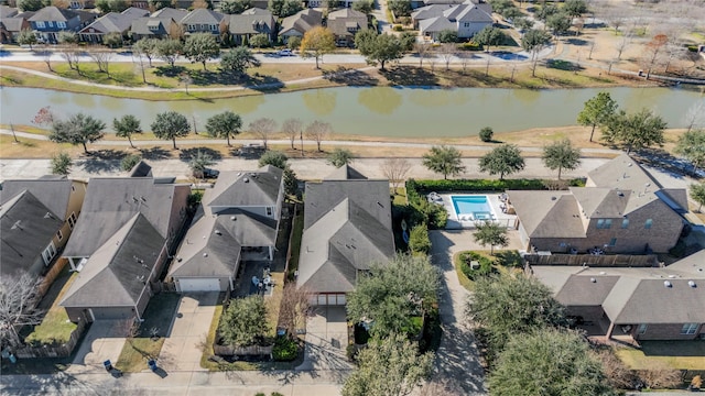 drone / aerial view with a residential view and a water view