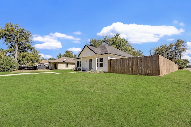 exterior space with a front yard and fence