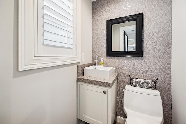 bathroom featuring toilet and vanity