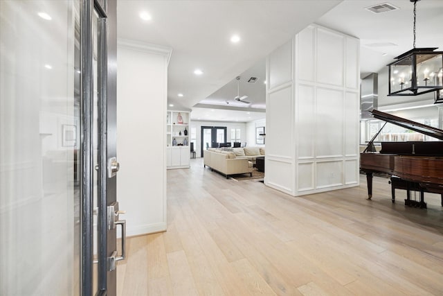 foyer entrance with recessed lighting, light wood-style floors, and visible vents