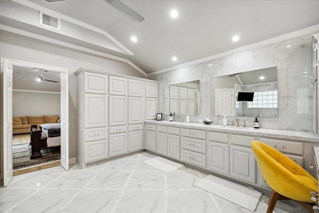 full bathroom featuring ceiling fan, lofted ceiling, marble finish floor, and ornamental molding