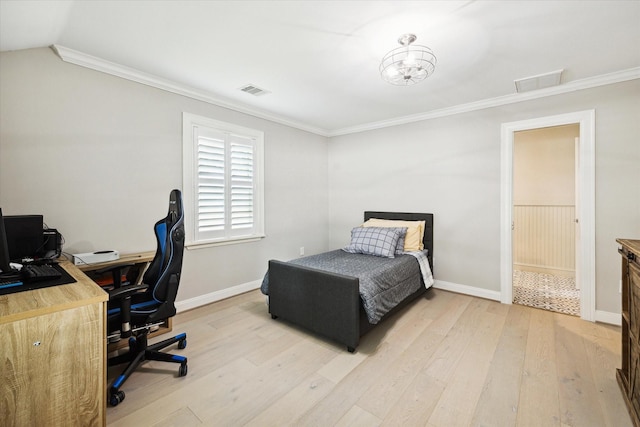 bedroom featuring crown molding, light wood-style floors, and baseboards