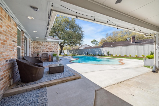 view of swimming pool featuring a fenced in pool, a fenced backyard, and a patio area