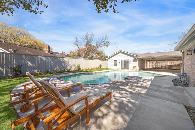 view of pool with a storage structure, a patio, an outbuilding, and a fenced backyard