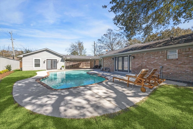 view of swimming pool with a patio, a fenced in pool, french doors, and fence