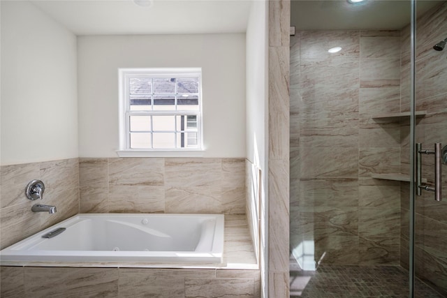 full bathroom with a tub with jets and a shower stall