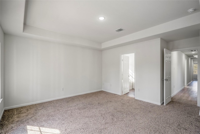 unfurnished room with recessed lighting, visible vents, baseboards, and carpet