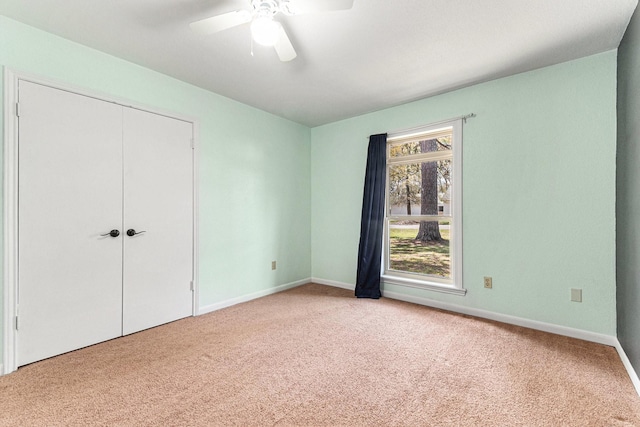 19331 E Lakeshore Dr, Magnolia, TX 77355 - unfurnished bedroom featuring carpet floors, baseboards, ceiling fan, and a closet