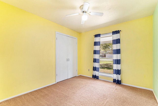 19331 E Lakeshore Dr, Magnolia, TX 77355 - spare room featuring carpet floors, baseboards, and a ceiling fan