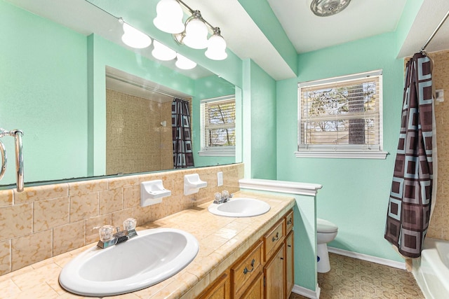 19331 E Lakeshore Dr, Magnolia, TX 77355 - bathroom featuring toilet, backsplash, and double vanity