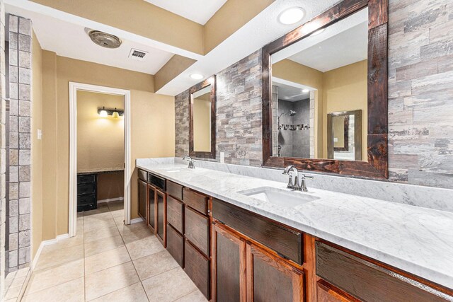 19331 E Lakeshore Dr, Magnolia, TX 77355 - full bath with tile patterned floors, double vanity, baseboards, and tiled shower
