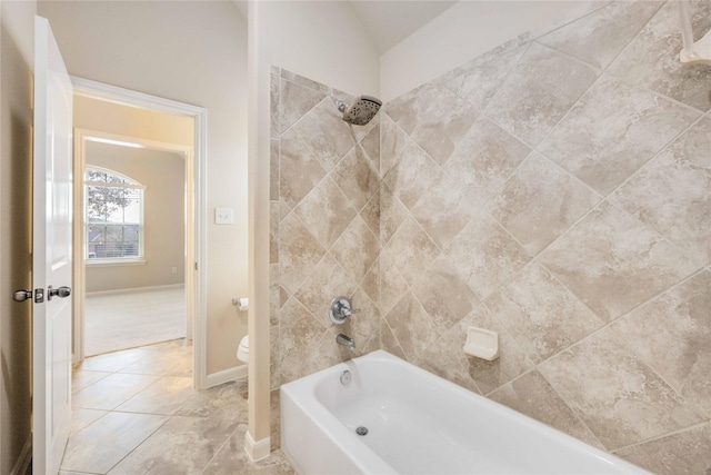 full bath with tile patterned flooring, toilet, baseboards, and shower / washtub combination