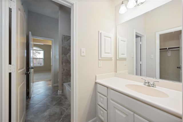 full bathroom featuring tile patterned floors, baseboards, bathing tub / shower combination, and vanity