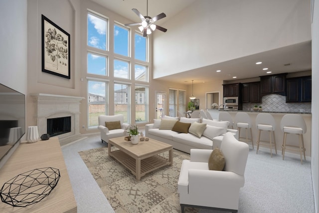 living area with a ceiling fan, plenty of natural light, a fireplace, and recessed lighting