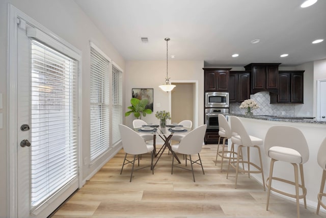 dining area featuring visible vents, recessed lighting, and light wood-type flooring