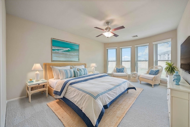 bedroom featuring light carpet, visible vents, baseboards, and ceiling fan