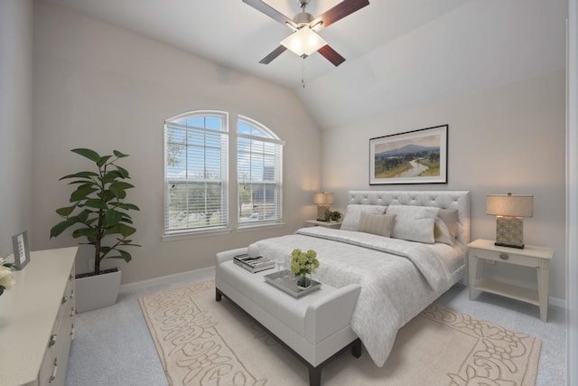 carpeted bedroom featuring baseboards, lofted ceiling, and ceiling fan