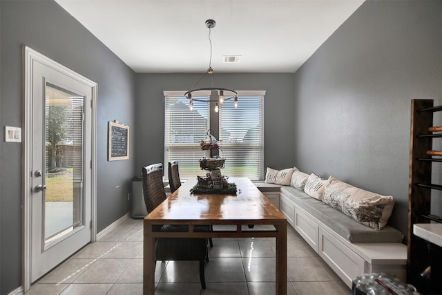 dining room featuring visible vents, baseboards, light tile patterned flooring, and a chandelier