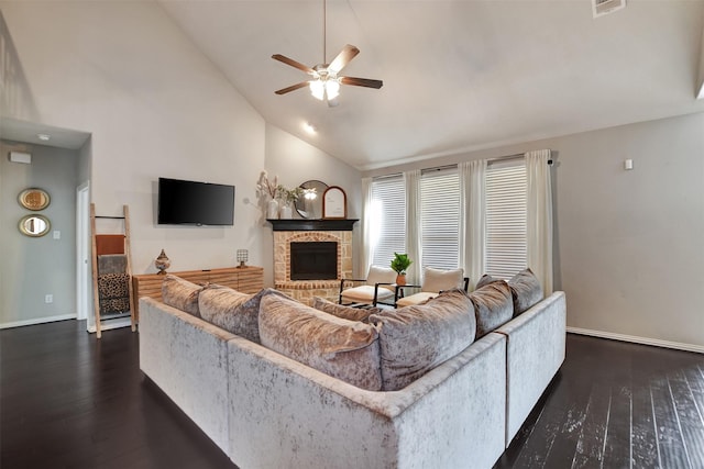 living area with baseboards, a fireplace with raised hearth, dark wood-style flooring, and high vaulted ceiling