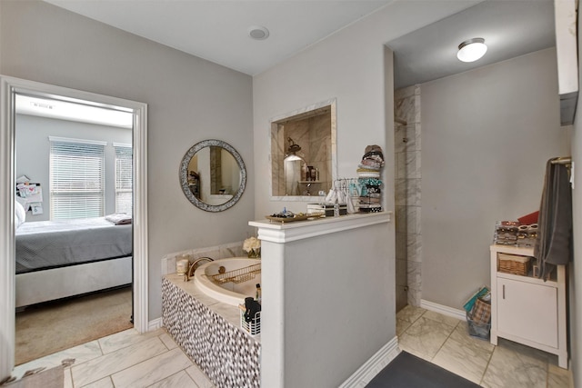 ensuite bathroom featuring a garden tub, marble finish floor, ensuite bathroom, and a walk in shower