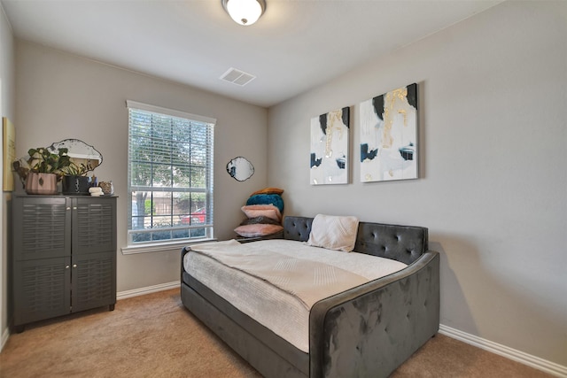 bedroom featuring visible vents, baseboards, and carpet