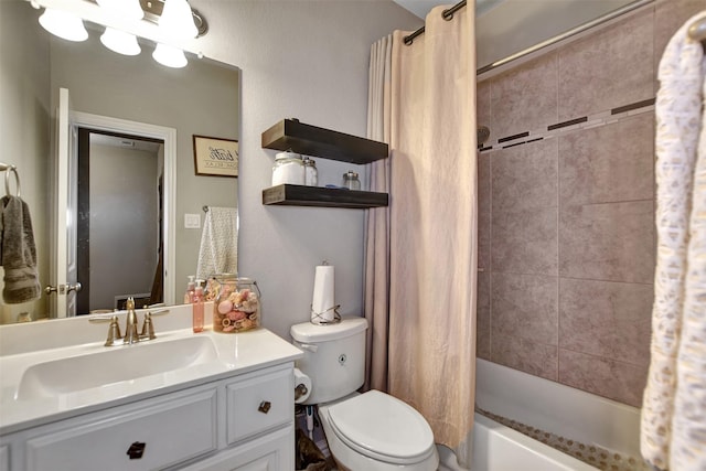 bathroom with shower / bath combo with shower curtain, toilet, and vanity