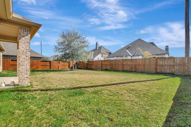 view of yard with a fenced backyard