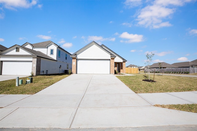 single story home with a front yard, fence, concrete driveway, a garage, and brick siding