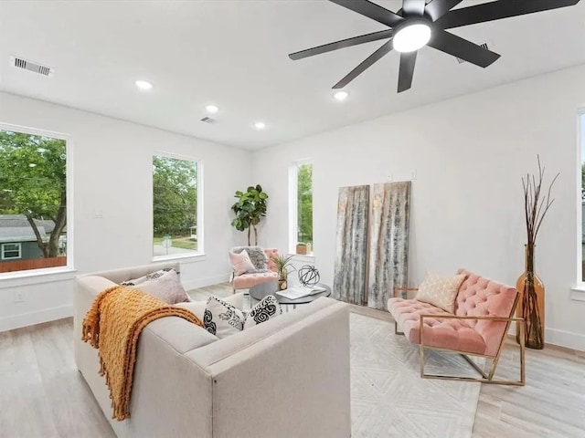 living area featuring recessed lighting, visible vents, light wood-style flooring, and baseboards