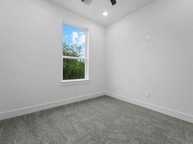 unfurnished room featuring dark colored carpet, baseboards, and ceiling fan