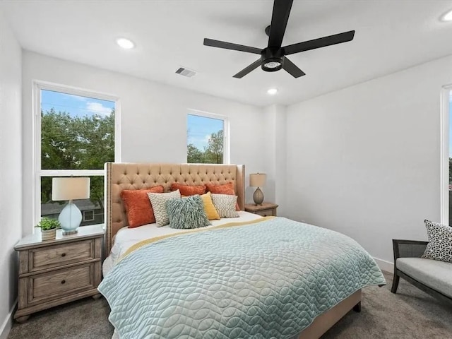 carpeted bedroom featuring baseboards, recessed lighting, visible vents, and ceiling fan