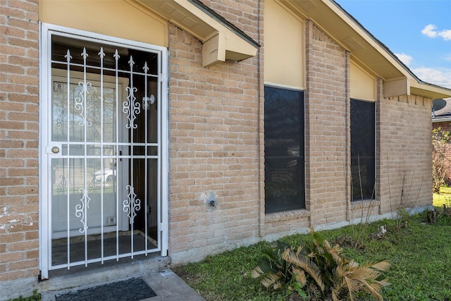 property entrance featuring brick siding