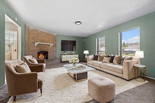 living area featuring a brick fireplace and carpet floors