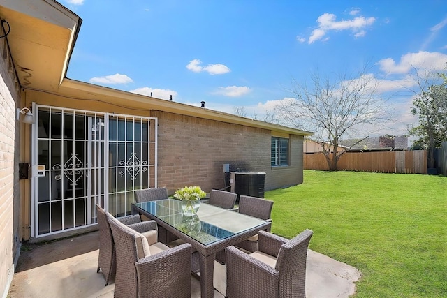 view of patio featuring central air condition unit, outdoor dining area, and fence