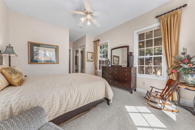 carpeted bedroom featuring baseboards and ceiling fan