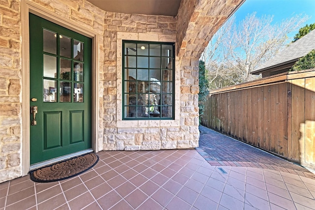 doorway to property featuring stone siding