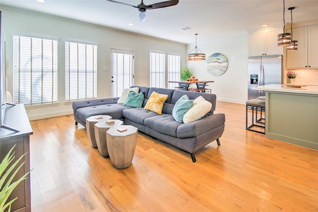 living room with light wood finished floors, recessed lighting, ceiling fan, and a healthy amount of sunlight