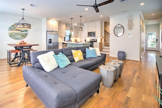 living room with baseboards, a ceiling fan, stairs, and recessed lighting