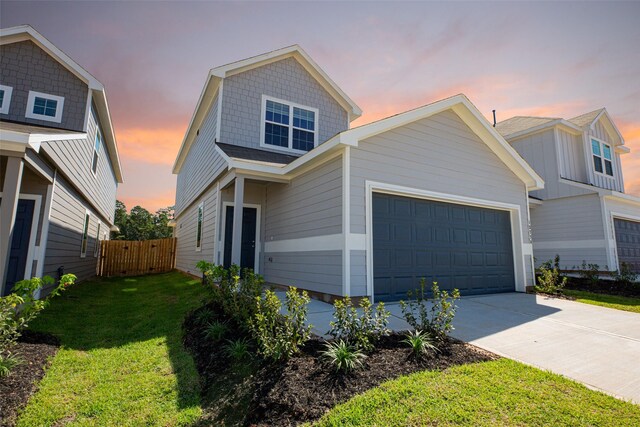 13774 Sunshine Peak Dr, Willis, TX 77318 - view of front facade featuring a garage, a yard, driveway, and fence