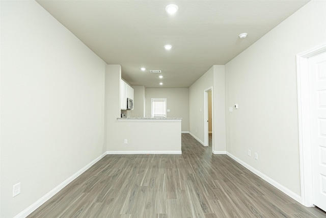 13774 Sunshine Peak Dr, Willis, TX 77318 - empty room featuring light wood-type flooring, visible vents, baseboards, and recessed lighting