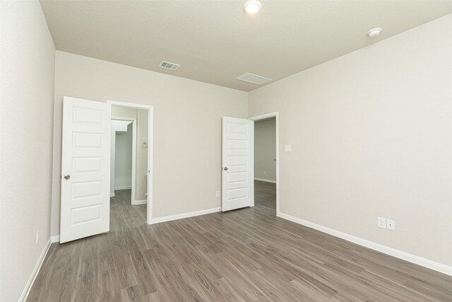 13774 Sunshine Peak Dr, Willis, TX 77318 - empty room with visible vents, baseboards, and wood finished floors