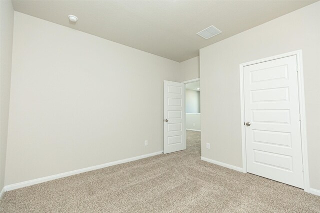13774 Sunshine Peak Dr, Willis, TX 77318 - unfurnished bedroom with visible vents, light colored carpet, and baseboards