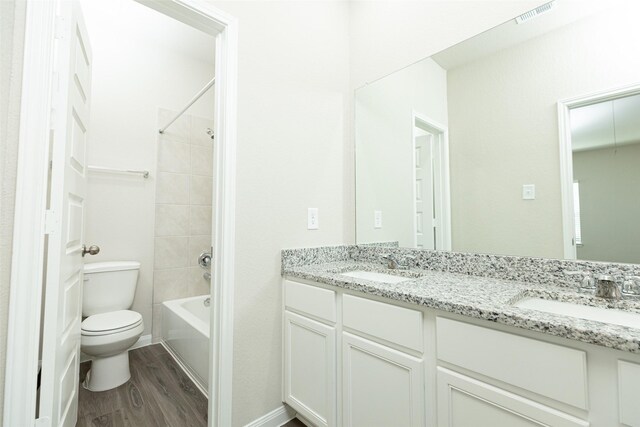13774 Sunshine Peak Dr, Willis, TX 77318 - full bath featuring visible vents, toilet, wood finished floors, and a sink