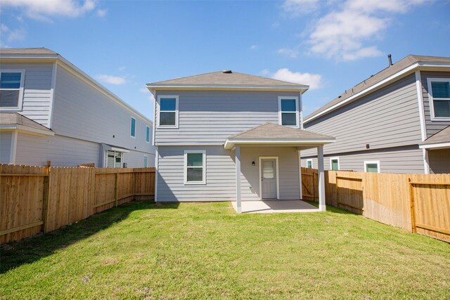 13774 Sunshine Peak Dr, Willis, TX 77318 - rear view of property featuring a patio area, a yard, and a fenced backyard